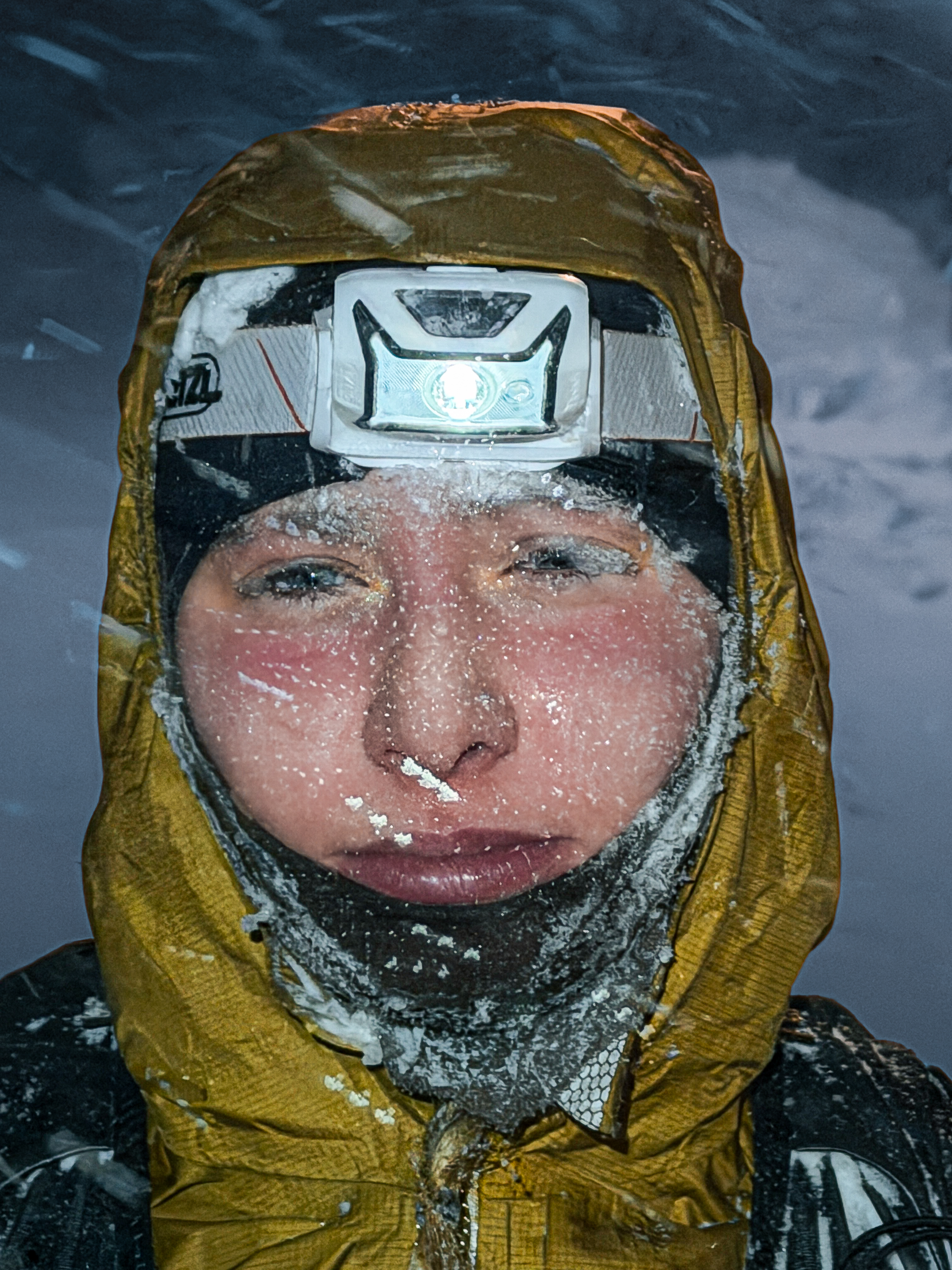 Portrait of runner Nina covered in frost with headlamp